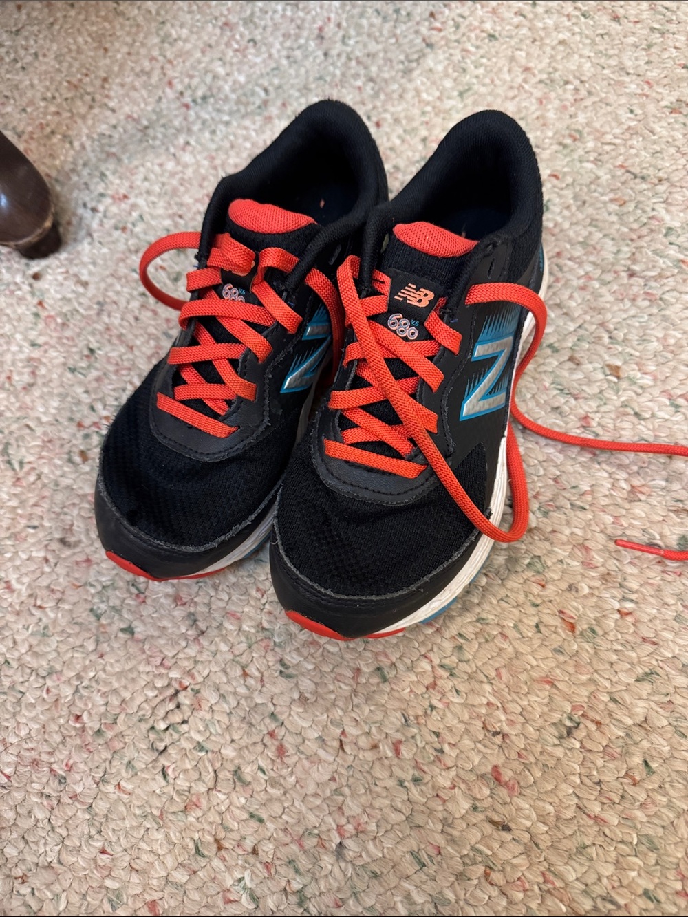 New Balance Kids Black Sneakers with Red Laces and Blue Logo